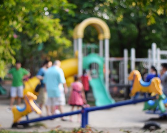 Colorful-playground-with-children-and-parents-in-park
